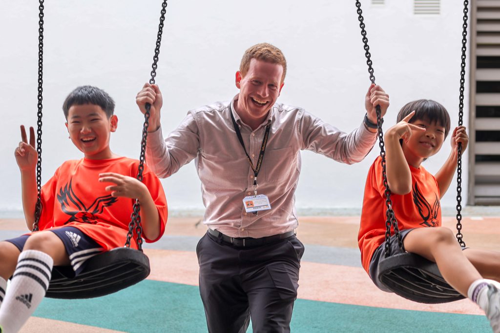 Elementary school principle playing with two students.